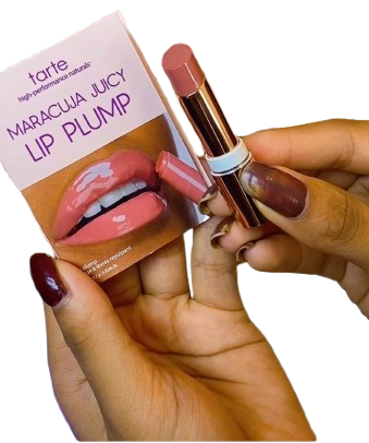 Lip plump with packaging held by a hand on a white background